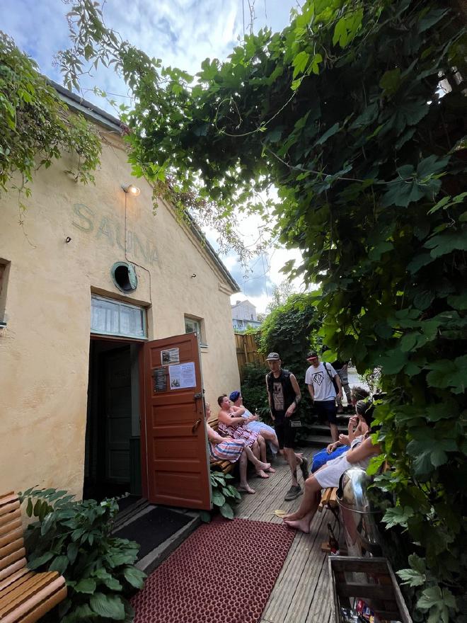 visitors resting by the sauna entrance